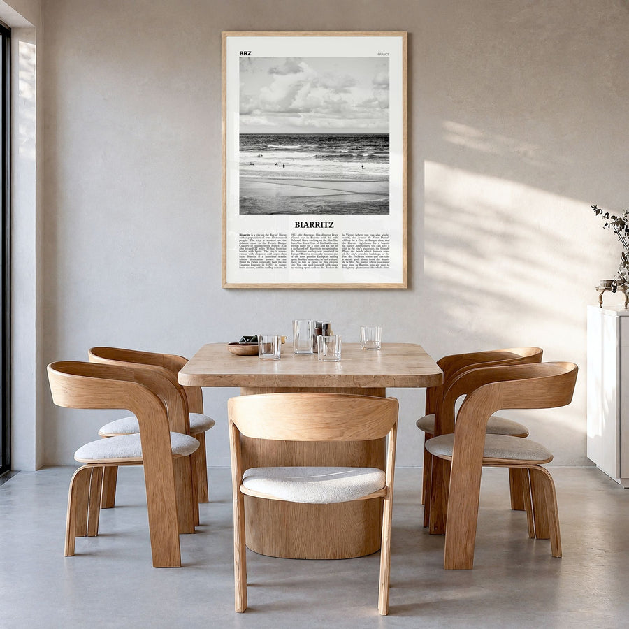Biarritz Newspaper Poster in a natural wood frame, hanging in a dining room