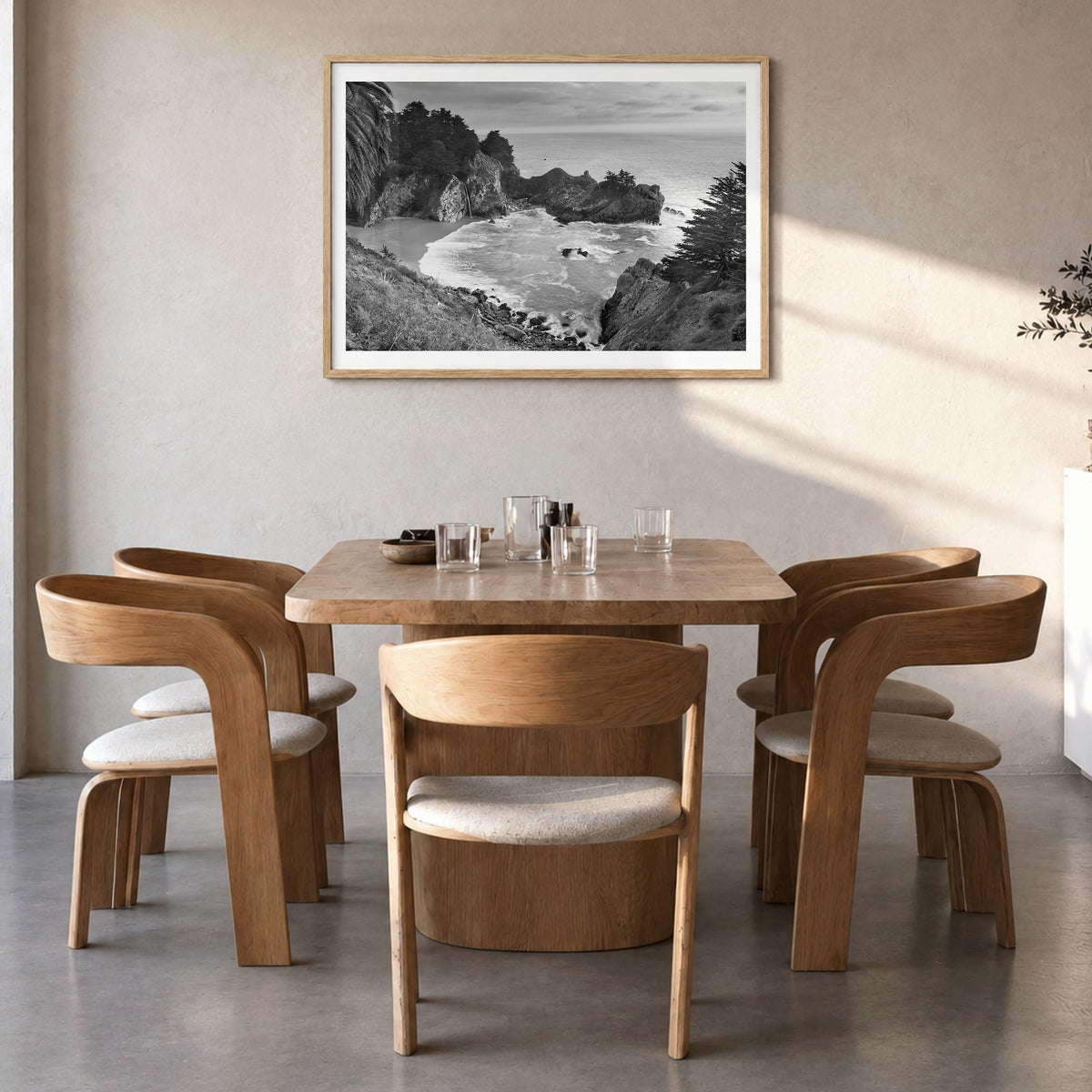 Big Sur Photo Poster in a natural wood frame, hanging in a dining room, white border