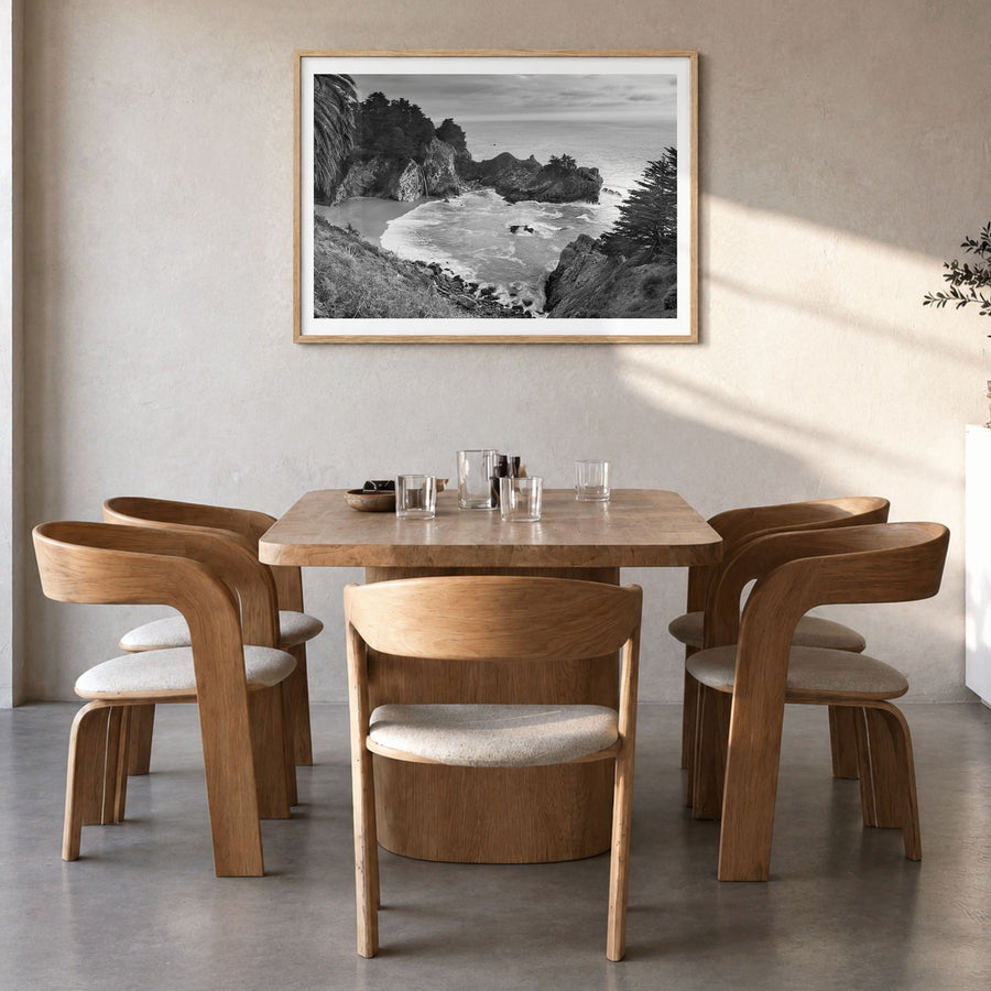 Big Sur Photo Poster in a natural wood frame, hanging in a dining room, white border