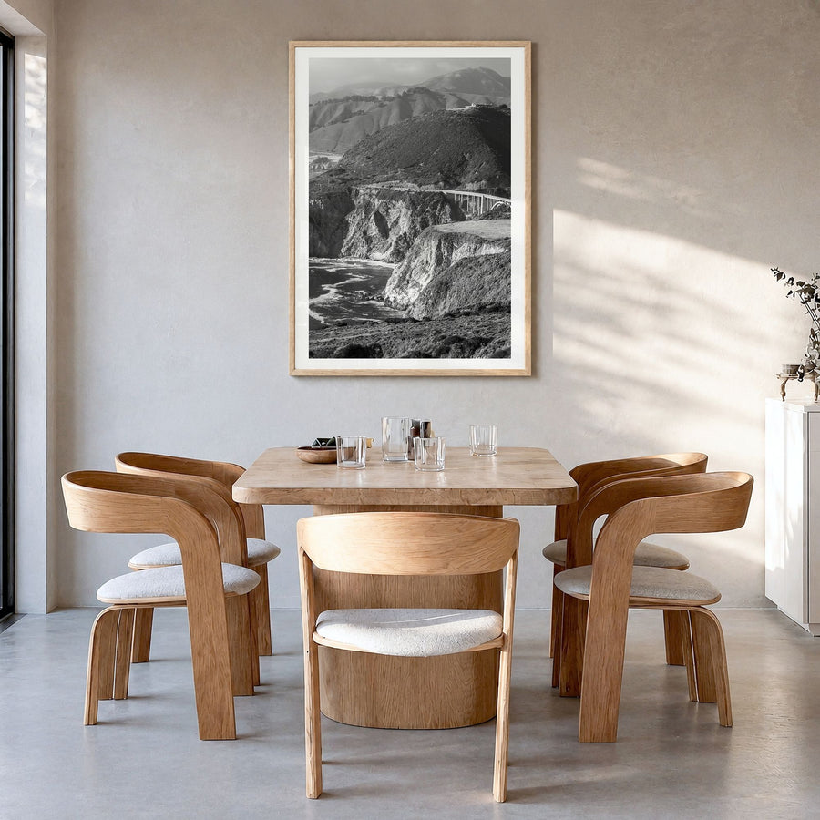 Big Sur Photo No 1 Poster in a natural wood frame, hanging in a dining room, white border