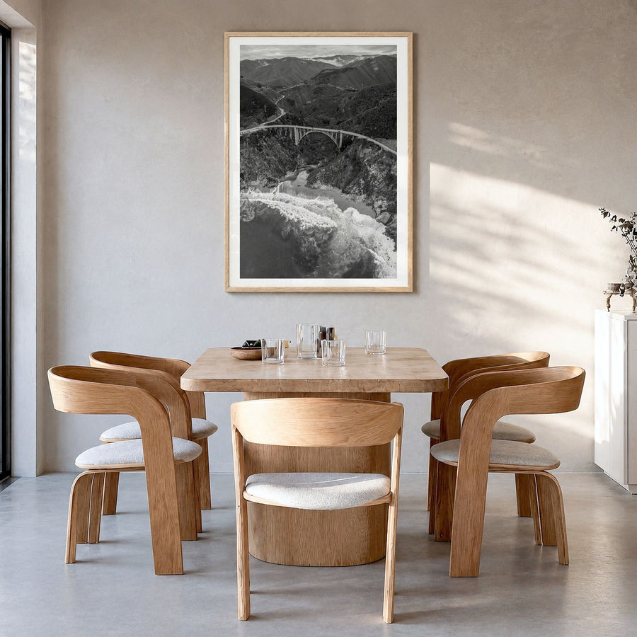 Big Sur Photo No 4 Poster in a natural wood frame, hanging in a dining room, white border