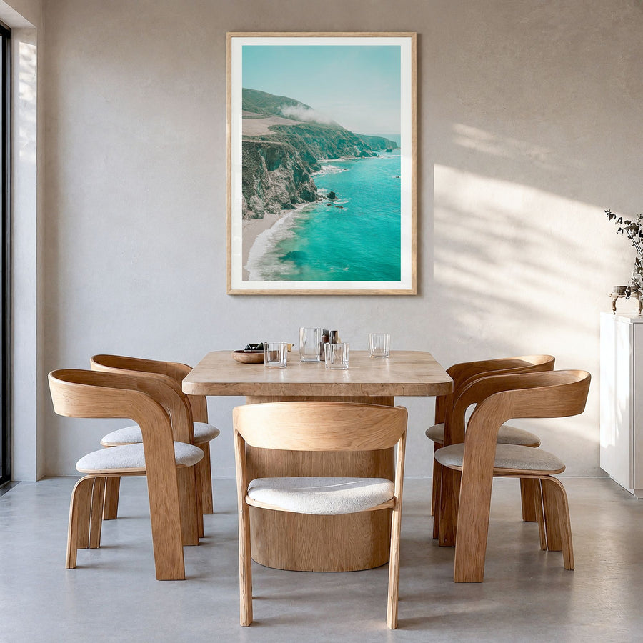 Big Sur Photo No 5 Poster in a natural wood frame, hanging in a dining room, white border