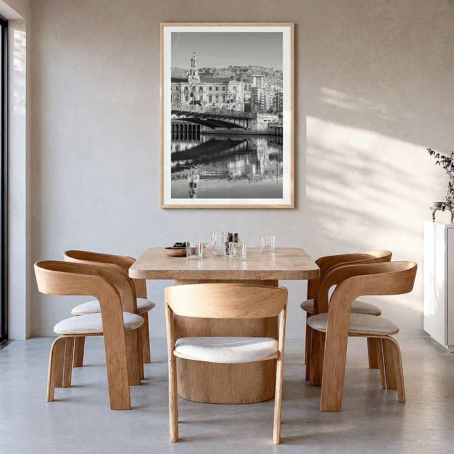 Bilbao Photo Poster in a natural wood frame, hanging in a dining room, white border