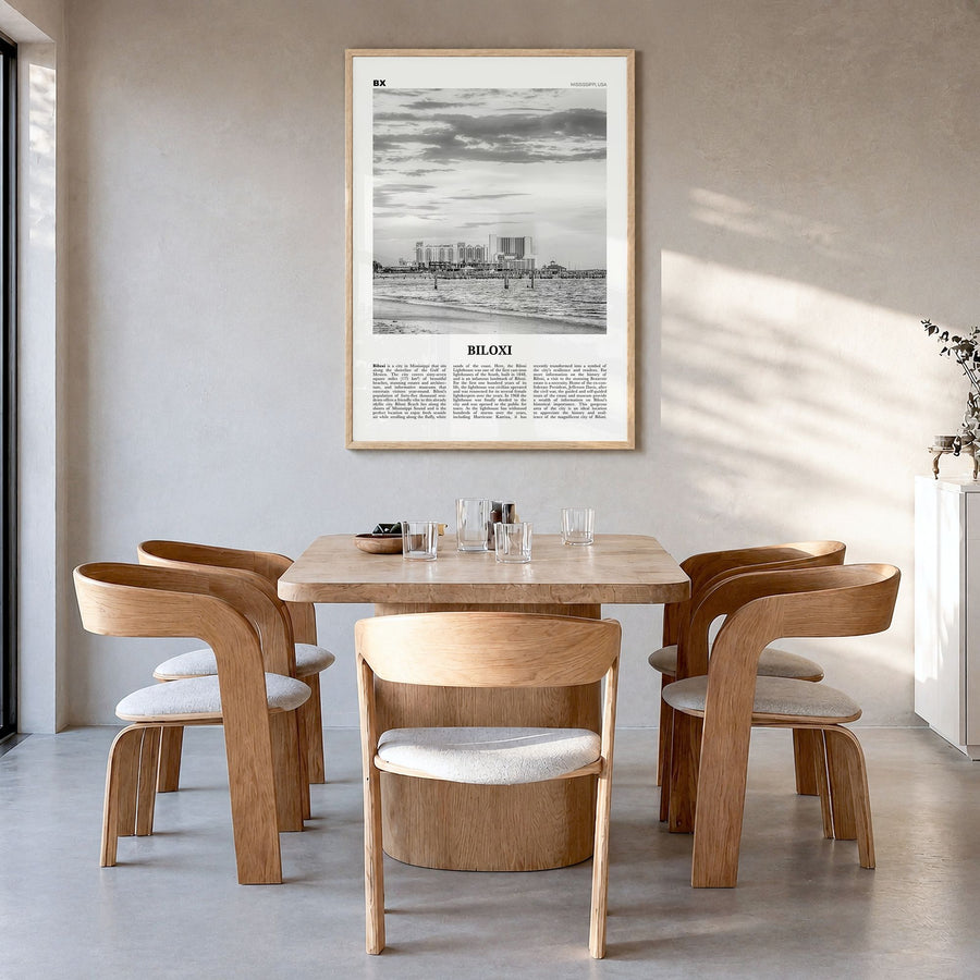 Biloxi Newspaper Poster in a natural wood frame, hanging in a dining room