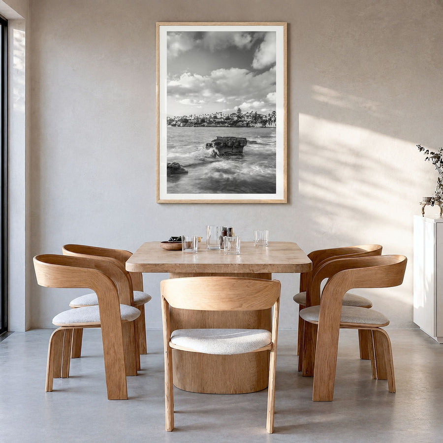 Bird Rock Photo Poster in a natural wood frame, hanging in a dining room, white border