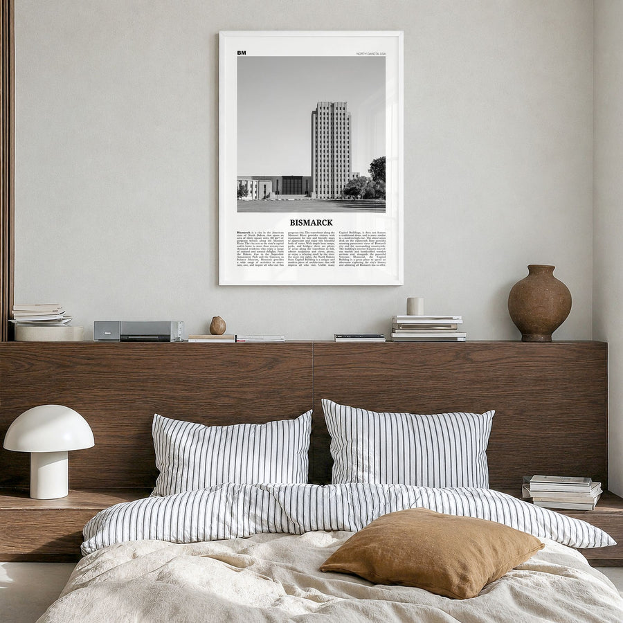 Bismarck Newspaper Poster in a white wood frame, hanging in a bedroom