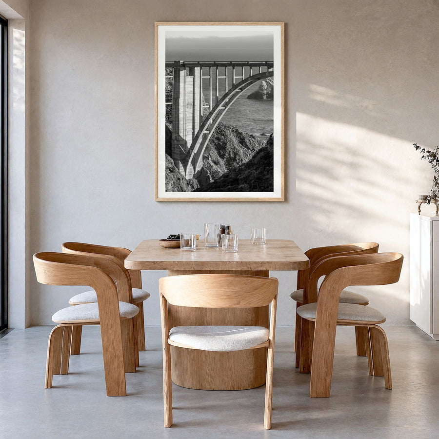Bixby Creek Bridge Photo Poster in a natural wood frame, hanging in a dining room, white border