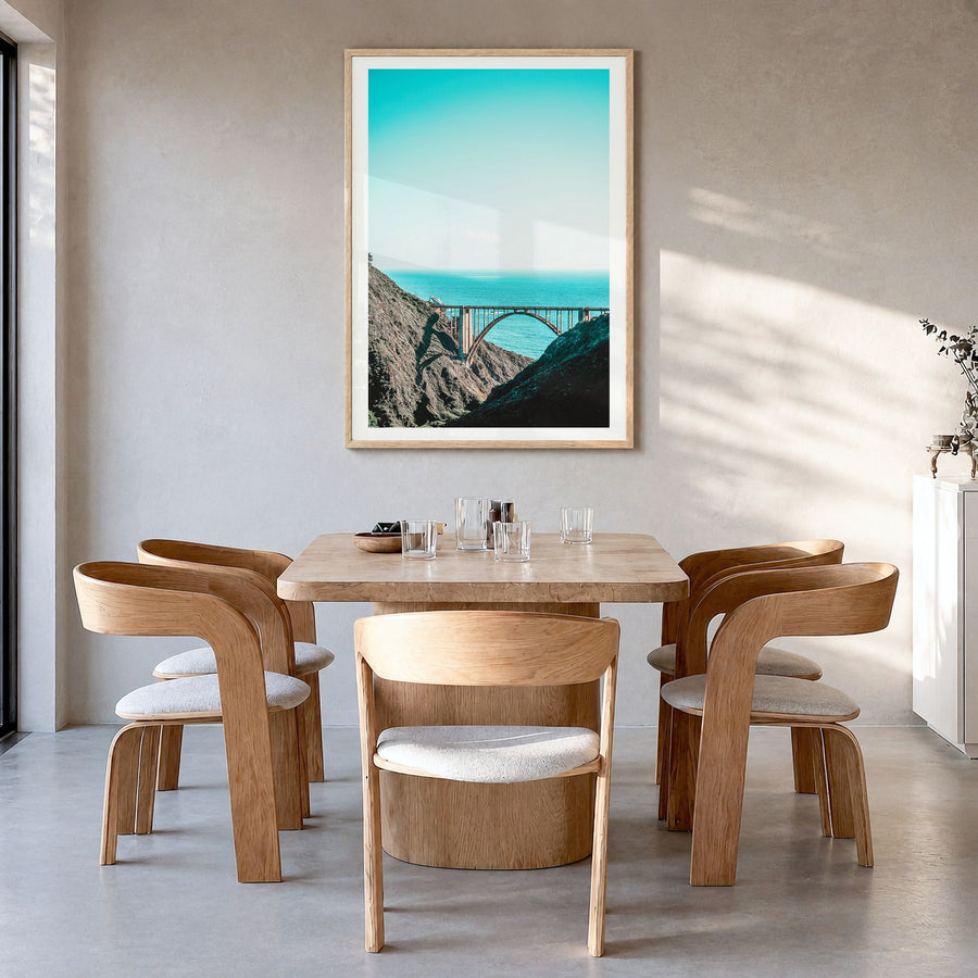 Bixby Creek Bridge Photo No 1 Poster in a natural wood frame, hanging in a dining room, white border