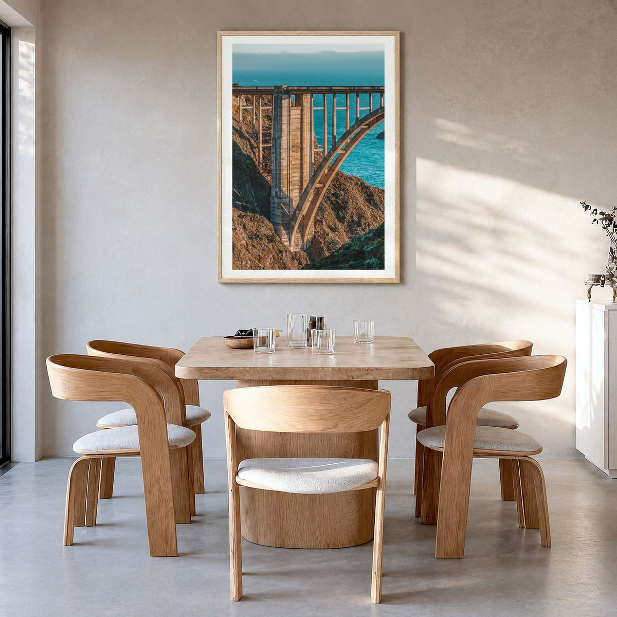 Bixby Creek Bridge Photo No 2 Poster in a natural wood frame, hanging in a dining room, white border
