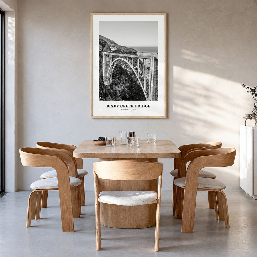 Bixby Creek Bridge Classic Poster in a natural wood frame, hanging in a dining room