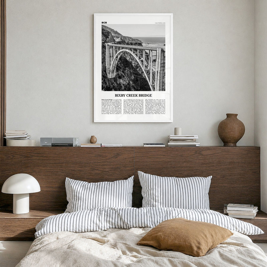 Bixby Creek Bridge Newspaper Poster in a white wood frame, hanging in a bedroom