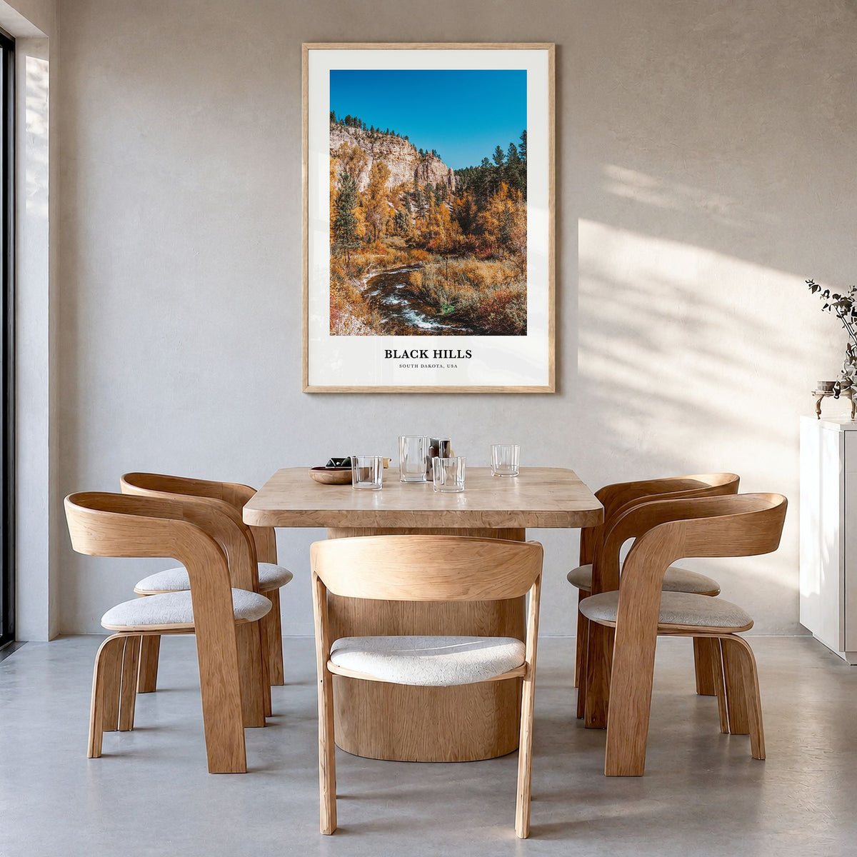Black Hills Classic Poster in a natural wood frame, hanging in a dining room