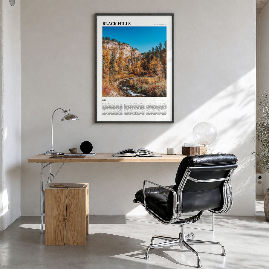 Black Hills Travel Poster in a black wood frame, hanging in a bright home office