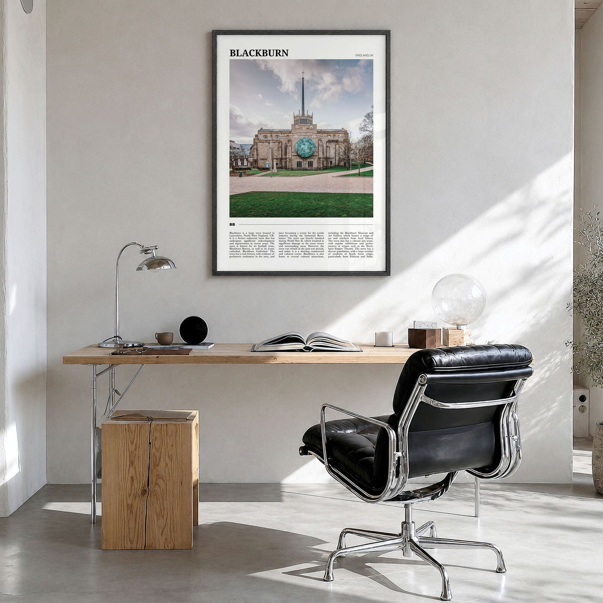 Blackburn Travel Poster in a black wood frame, hanging in a bright home office