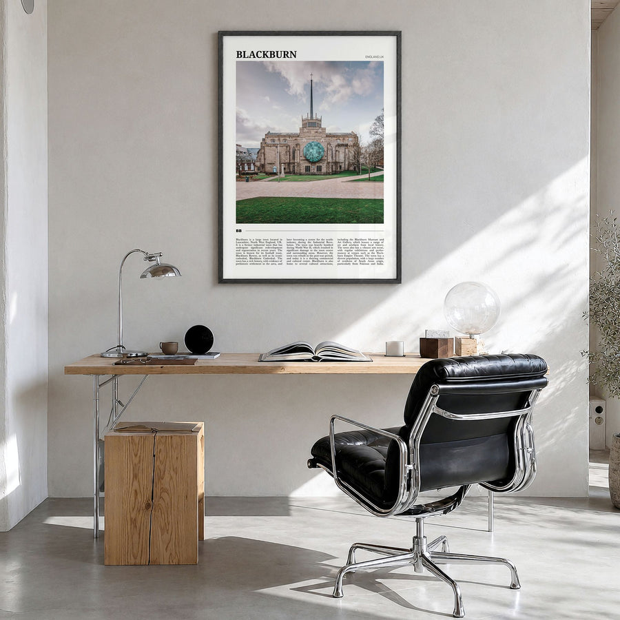 Blackburn Travel Poster in a black wood frame, hanging in a bright home office