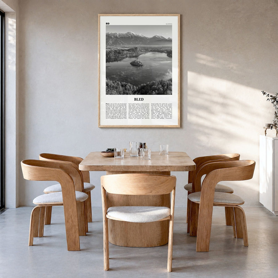 Bled Newspaper Poster in a natural wood frame, hanging in a dining room