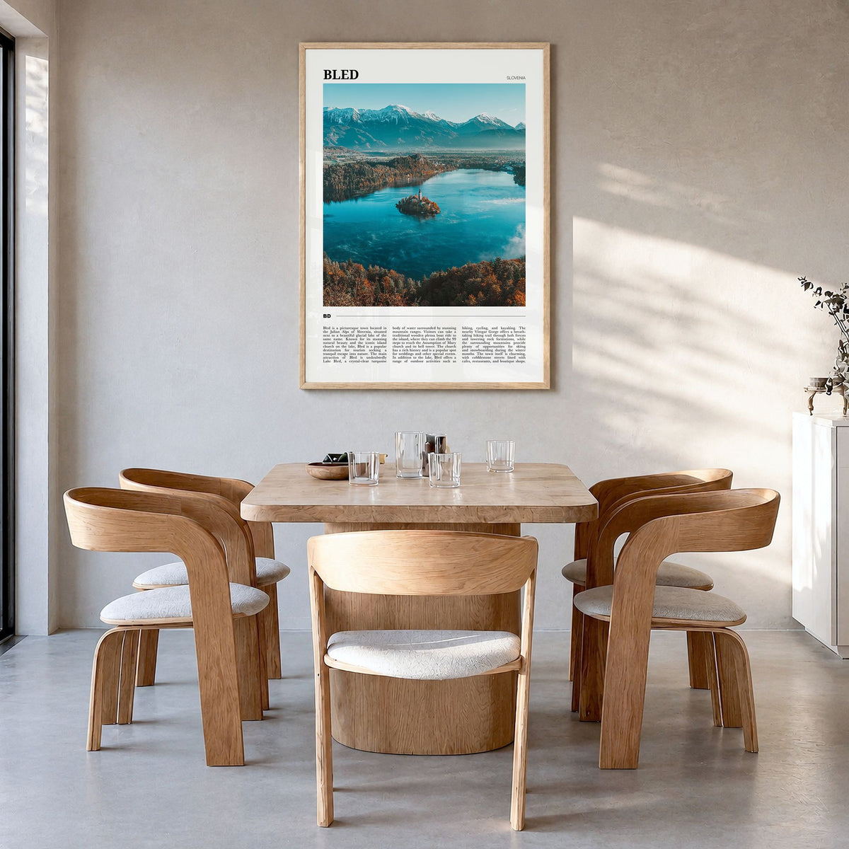 Bled Travel Poster in a natural wood frame, hanging in a dining room