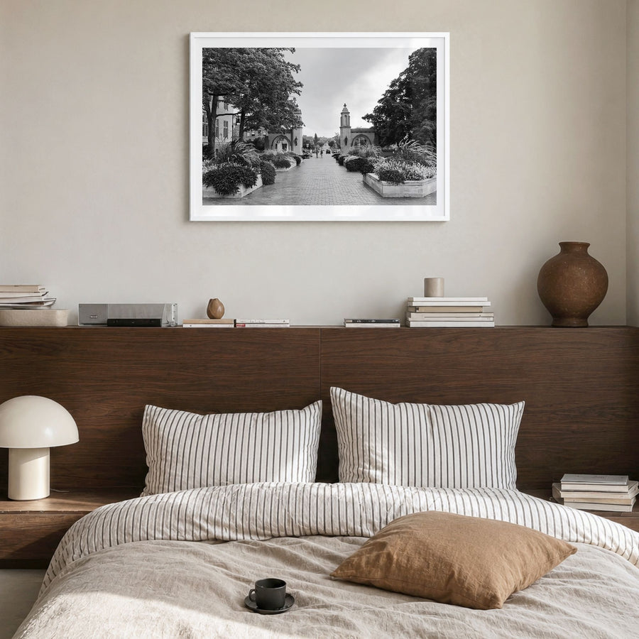 Bloomington Photo Poster in a white wood frame, hanging in a bedroom, white border