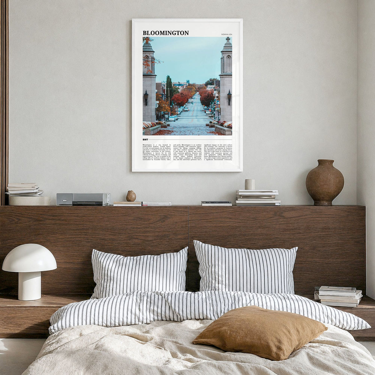 Bloomington Travel Poster in a white wood frame, hanging in a bedroom