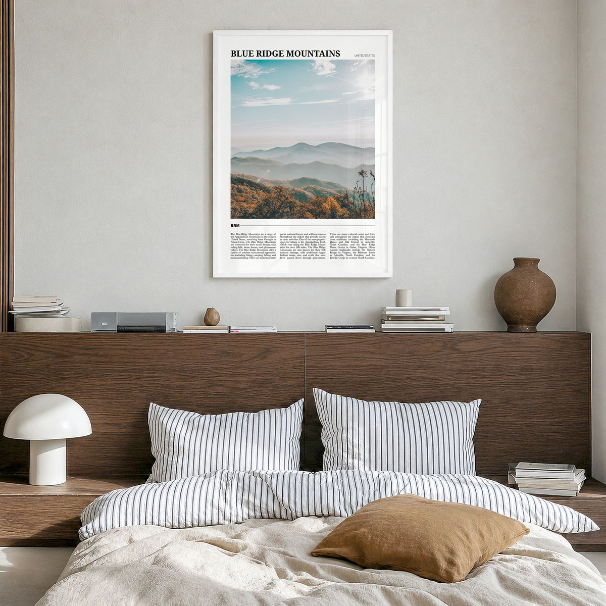 Blue Ridge Mountains Travel Poster in a white wood frame, hanging in a bedroom