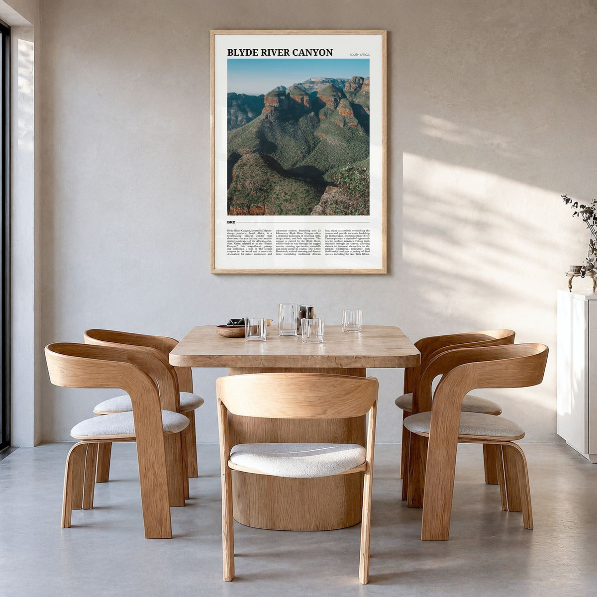 Blyde River Canyon Travel Poster in a natural wood frame, hanging in a dining room