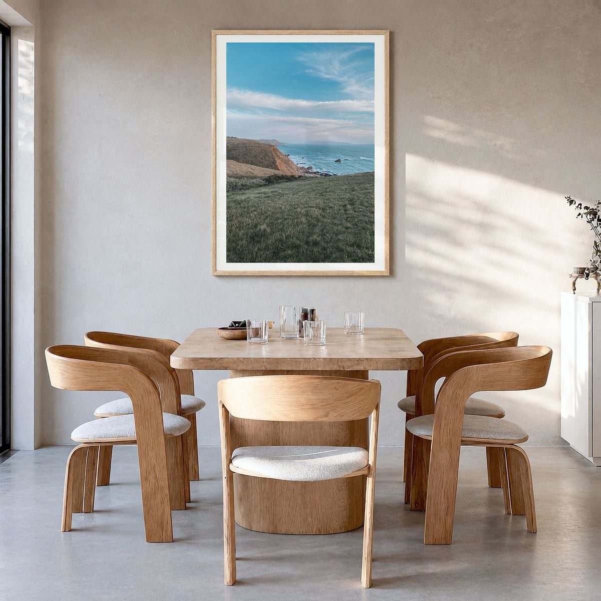 Bodega Bay Photo Poster in a natural wood frame, hanging in a dining room, white border