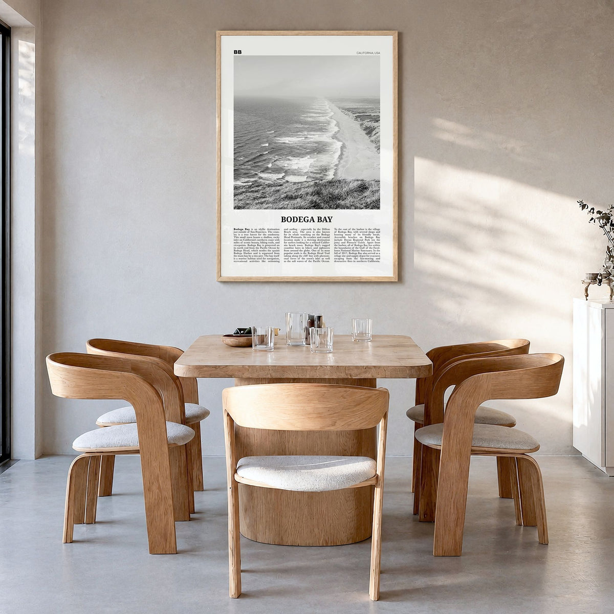 Bodega Bay Newspaper Poster in a natural wood frame, hanging in a dining room