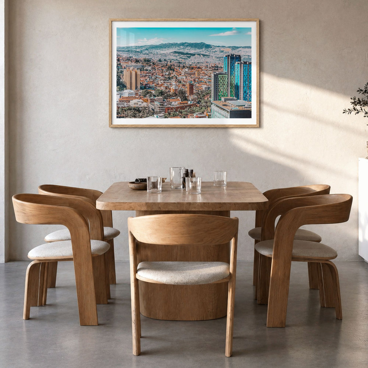 Bogotá Photo No 1 Poster in a natural wood frame, hanging in a dining room, white border