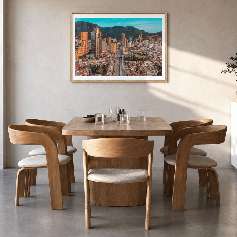 Bogotá Photo No 2 Poster in a natural wood frame, hanging in a dining room, white border