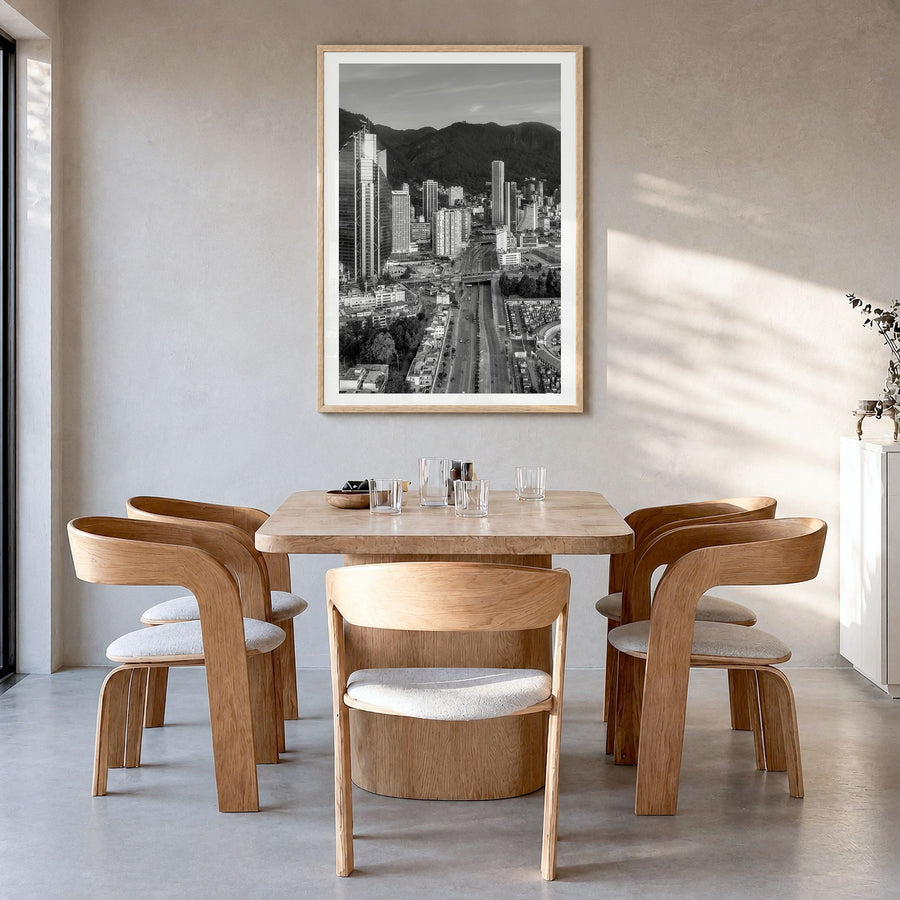 Bogotá Photo Poster in a natural wood frame, hanging in a dining room, white border