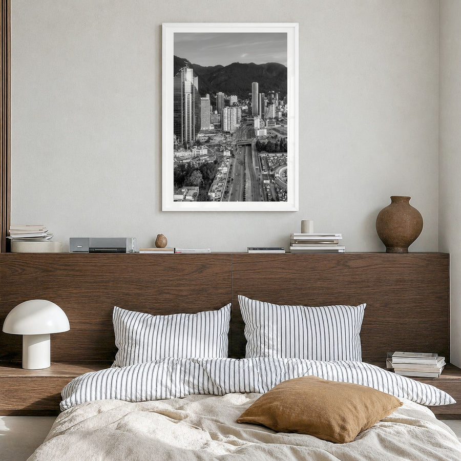 Bogotá Photo Poster in a white wood frame, hanging in a bedroom, white border