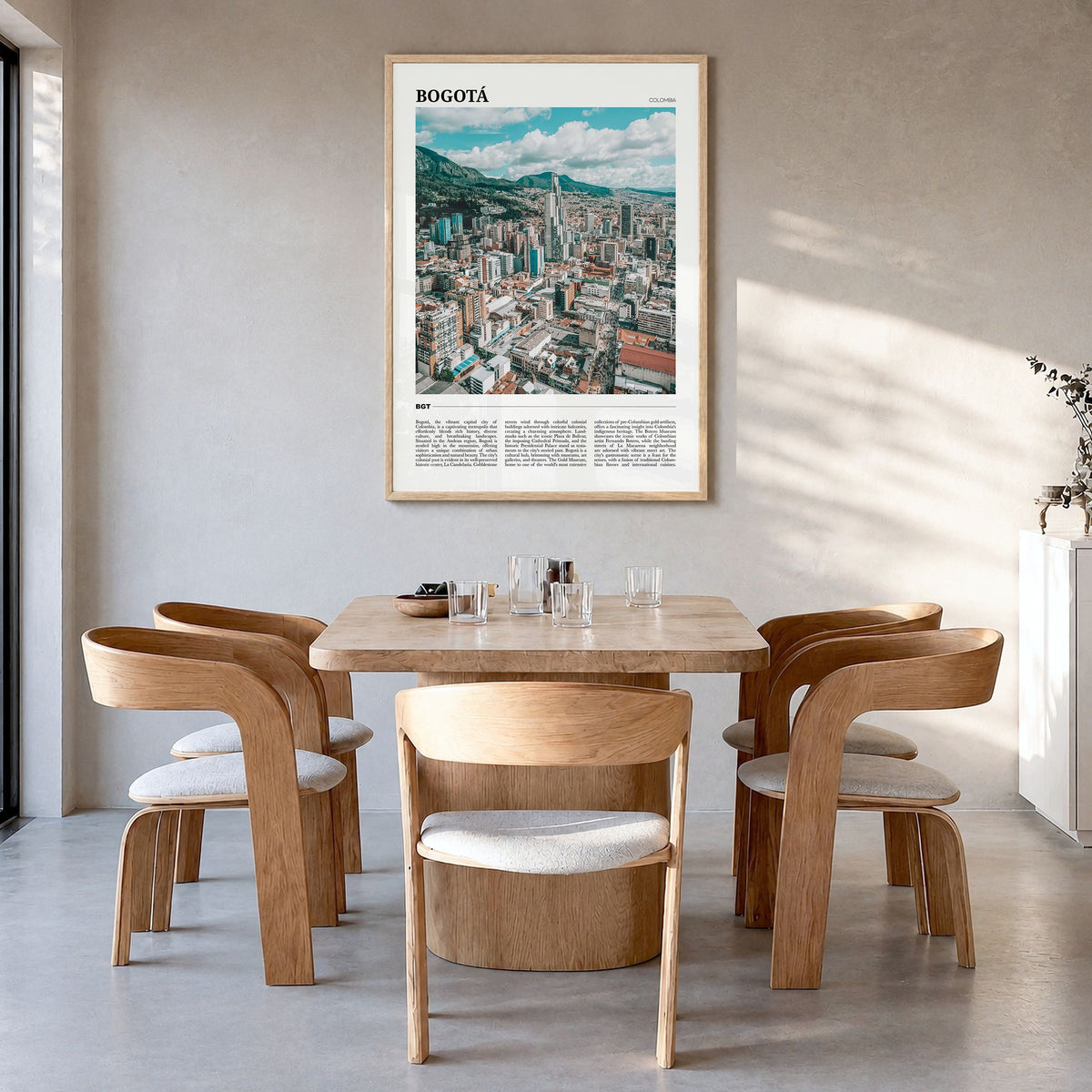 Bogotá Travel Poster in a natural wood frame, hanging in a dining room