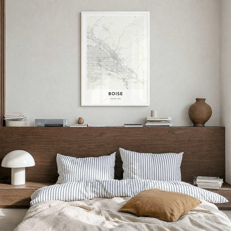 Boise Map Poster in a white wood frame, hanging in a bedroom