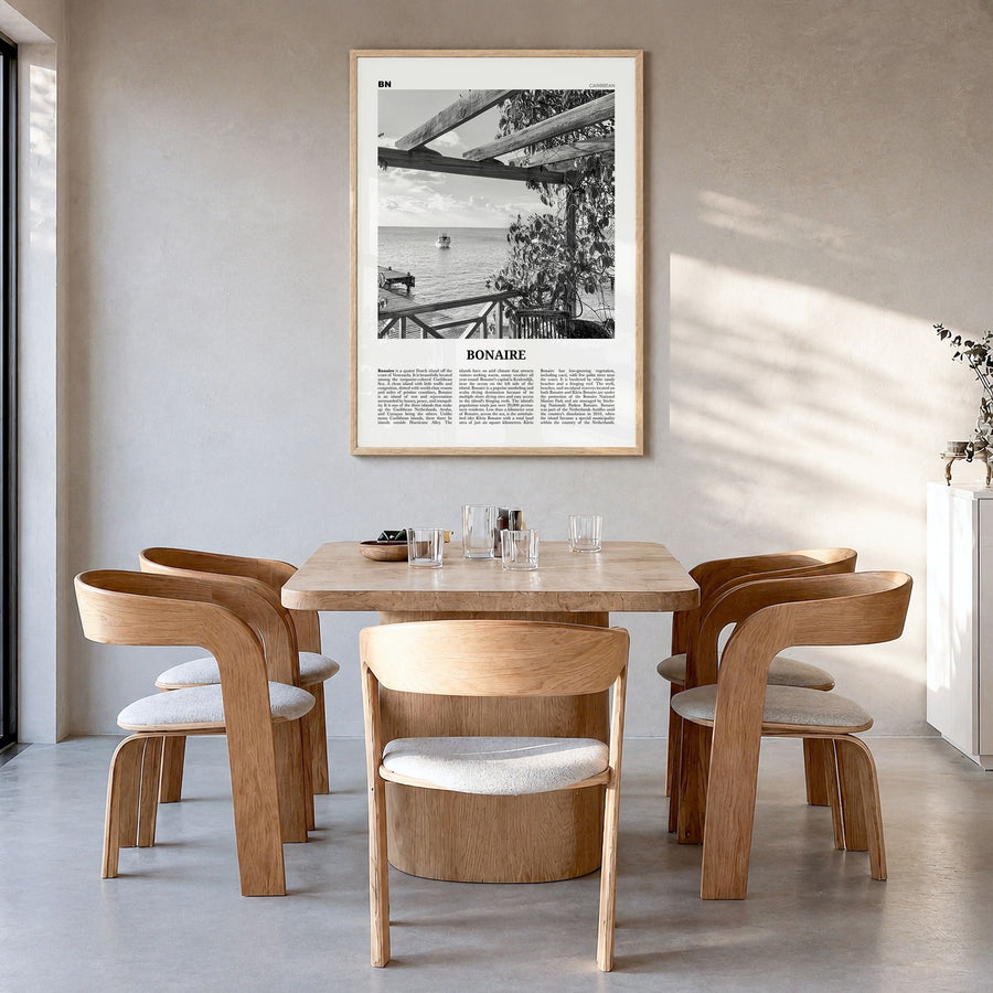 Bonaire Newspaper Poster in a natural wood frame, hanging in a dining room