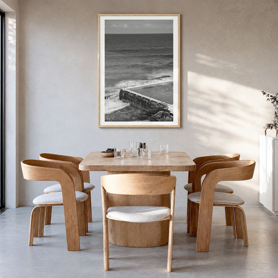 Bondi Beach Photo No 1 Poster in a natural wood frame, hanging in a dining room, white border