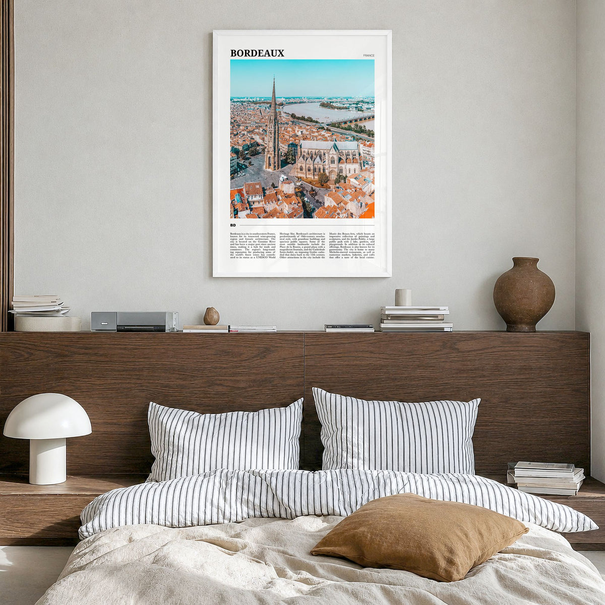 Bordeaux Travel Poster in a white wood frame, hanging in a bedroom