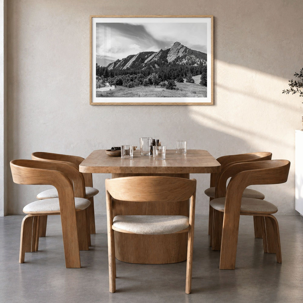 Boulder Photo Poster in a natural wood frame, hanging in a dining room, white border