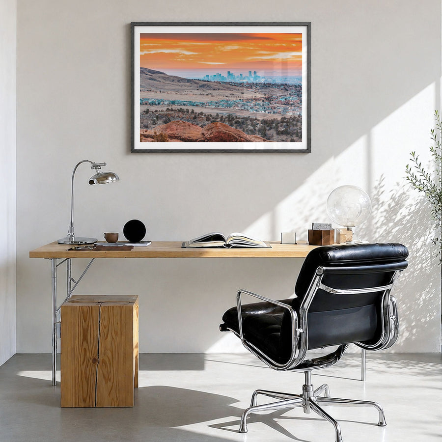 Boulder Photo Poster in a black wood frame, hanging in a bright home office, white border