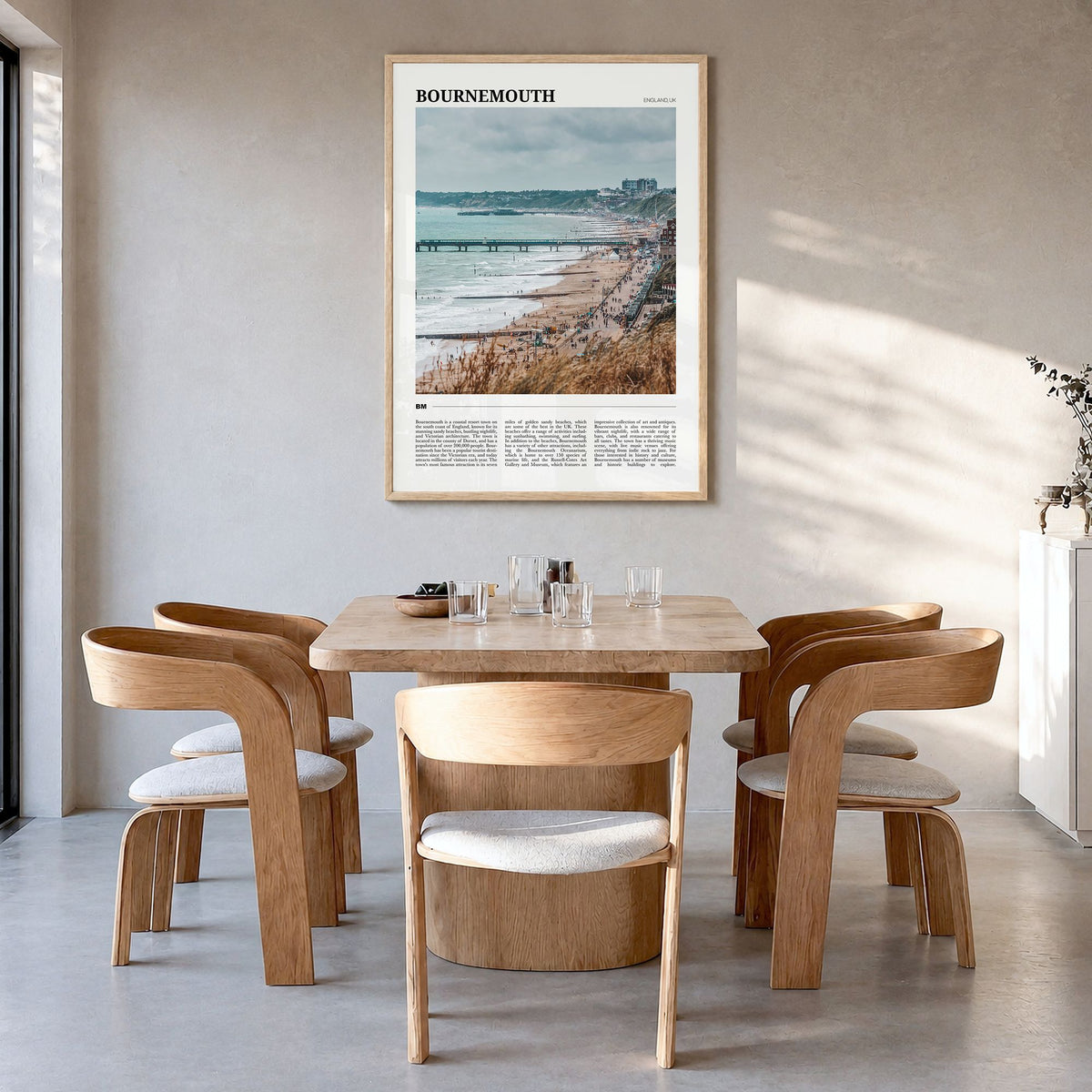 Bournemouth Travel Poster in a natural wood frame, hanging in a dining room