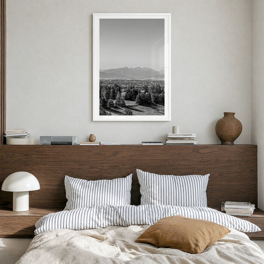 Bozeman Photo Poster in a white wood frame, hanging in a bedroom, white border