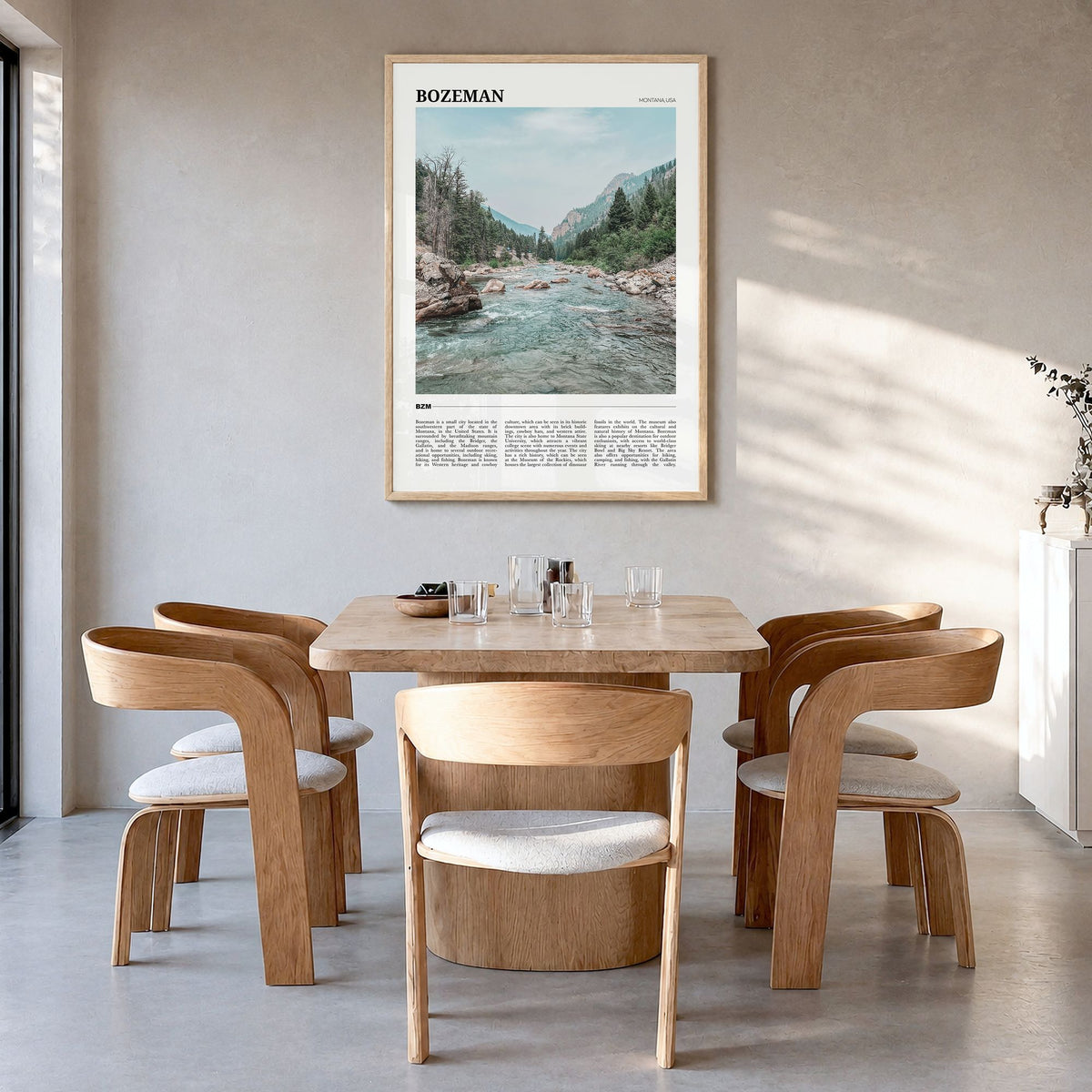 Bozeman Travel Poster in a natural wood frame, hanging in a dining room