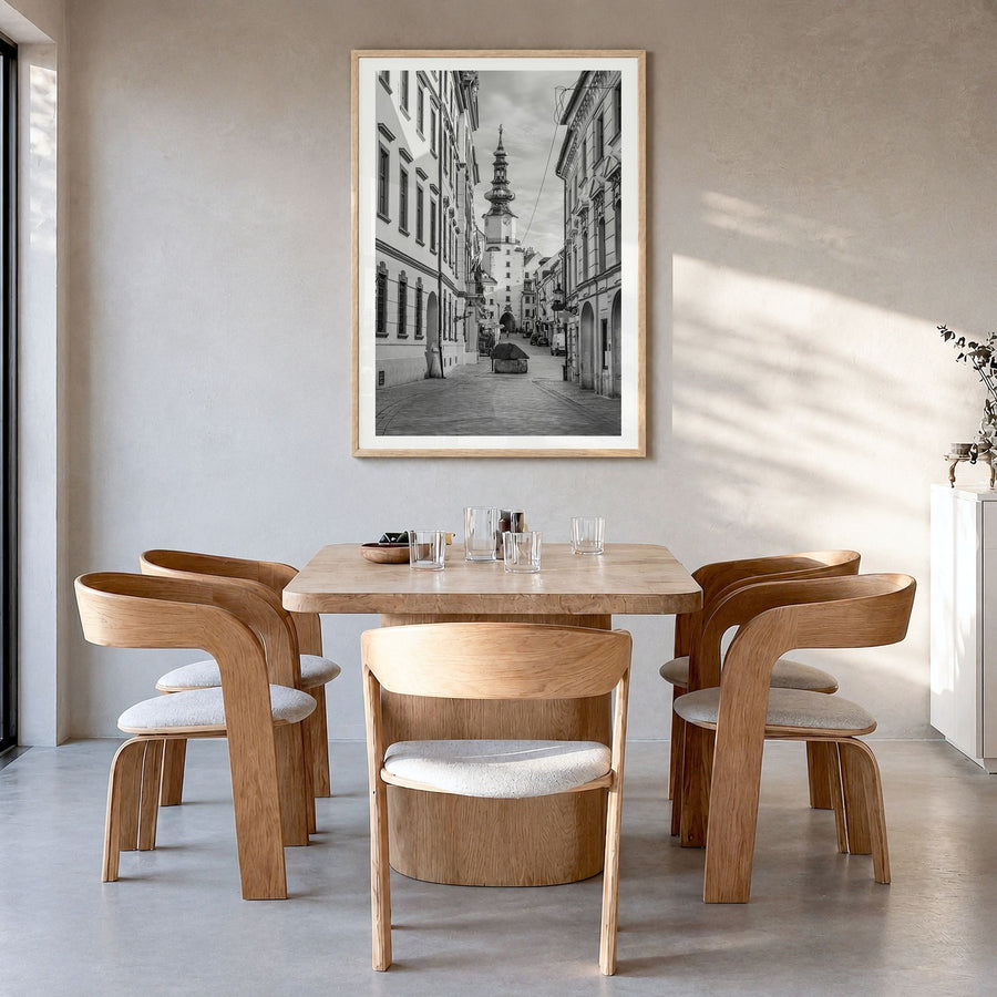 Bratislava Photo Poster in a natural wood frame, hanging in a dining room, white border