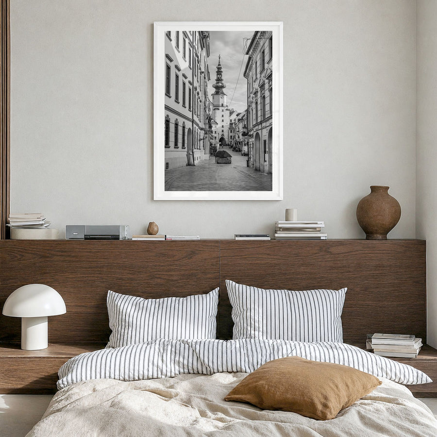 Bratislava Photo Poster in a white wood frame, hanging in a bedroom, white border