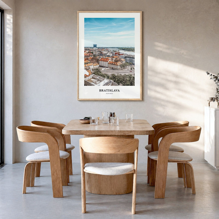 Bratislava Classic Poster in a natural wood frame, hanging in a dining room