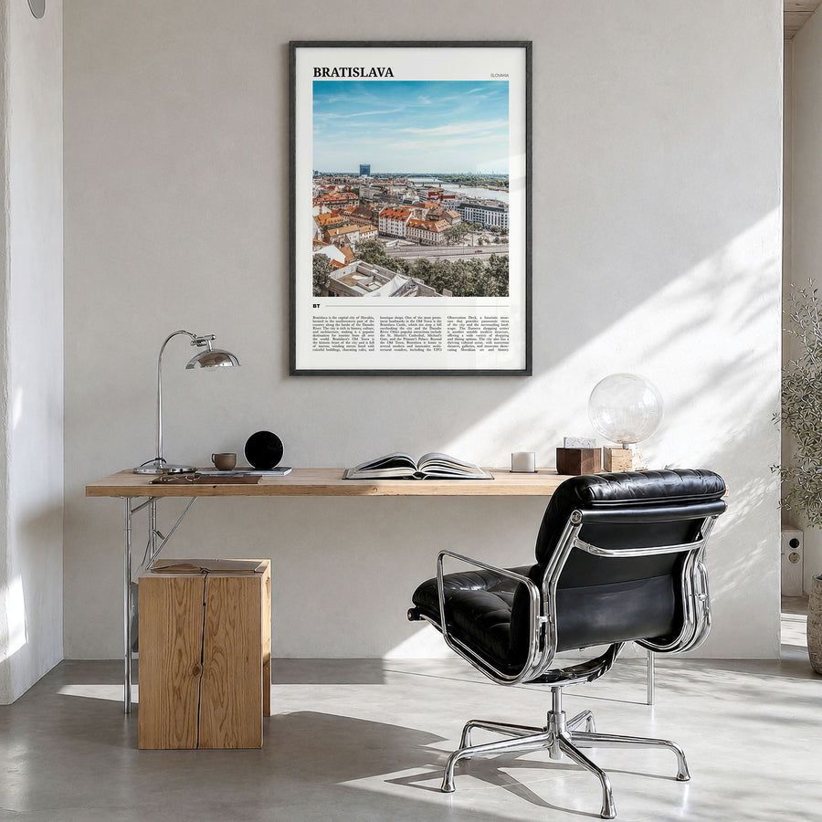 Bratislava Travel Poster in a black wood frame, hanging in a bright home office
