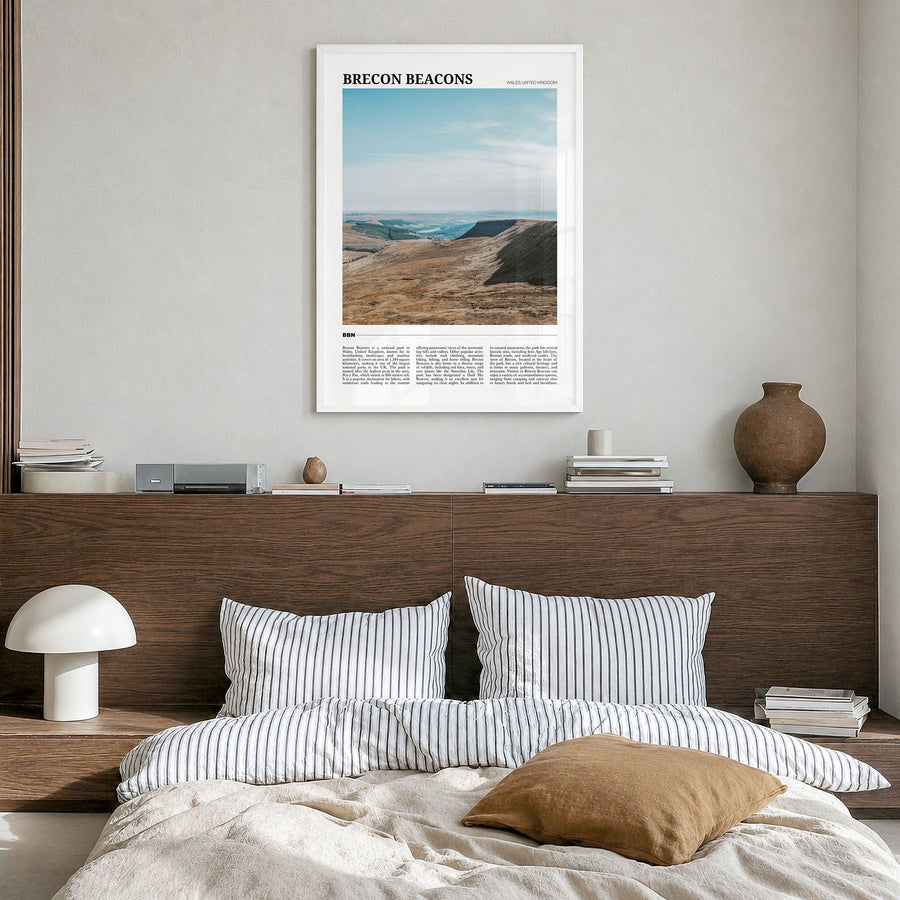 Brecon Beacons Travel Poster in a white wood frame, hanging in a bedroom