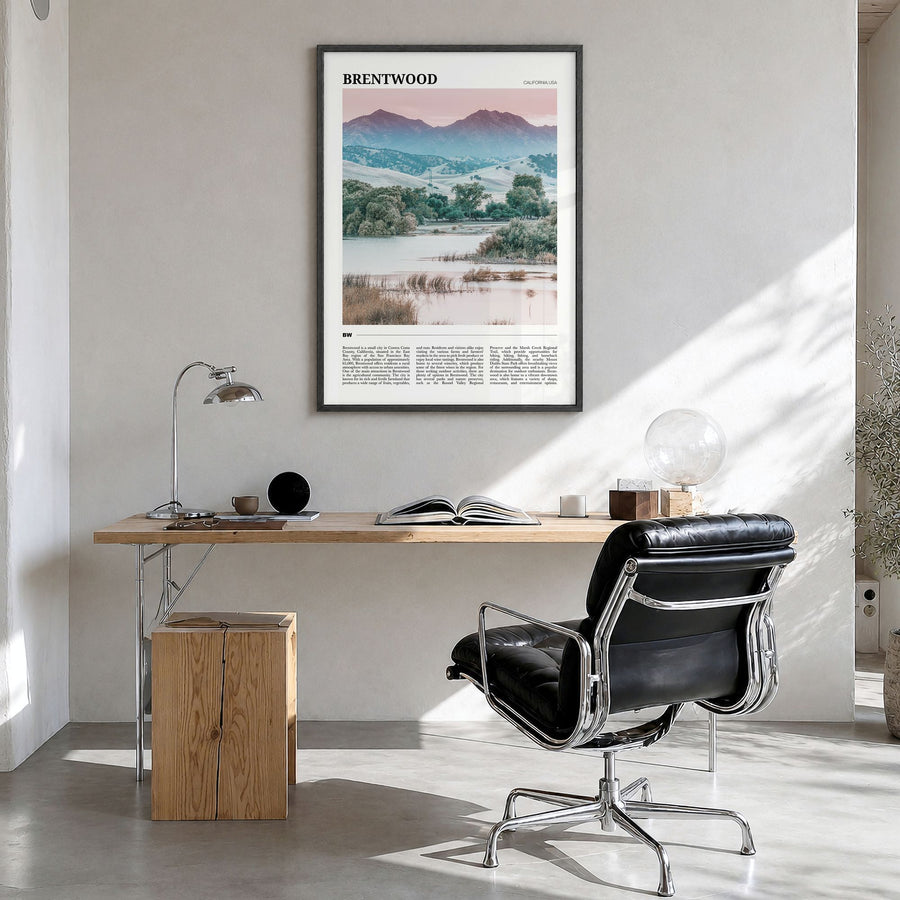 Brentwood Travel Poster in a black wood frame, hanging in a bright home office