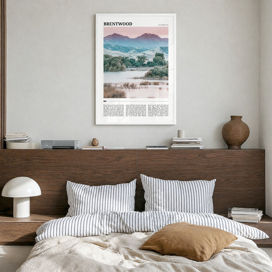 Brentwood Travel Poster in a white wood frame, hanging in a bedroom