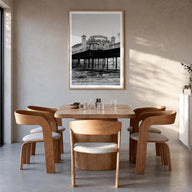 Brighton black & white photo poster of England, UK – vertical wall art in natural wood frame with white border, hanging on wa