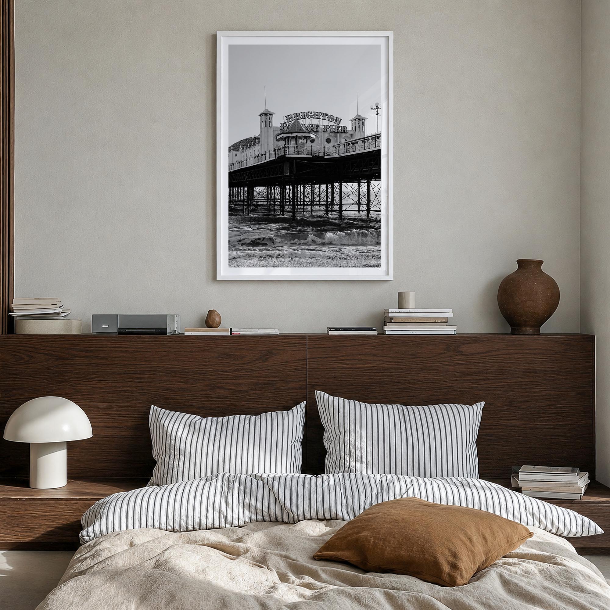 Brighton black & white photo poster of England, UK – vertical wall art in white wood frame with white border, hanging on wall